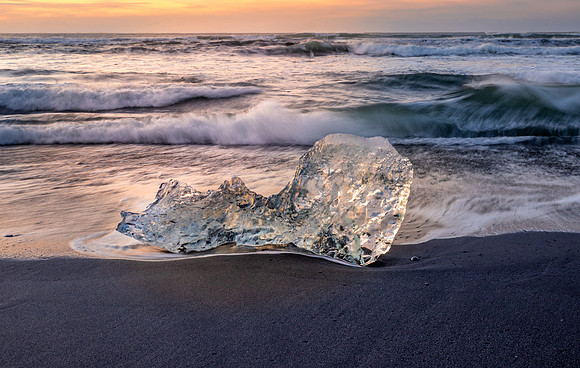Small iceberg piece at sunrise on Diamond Beach, Iceland
